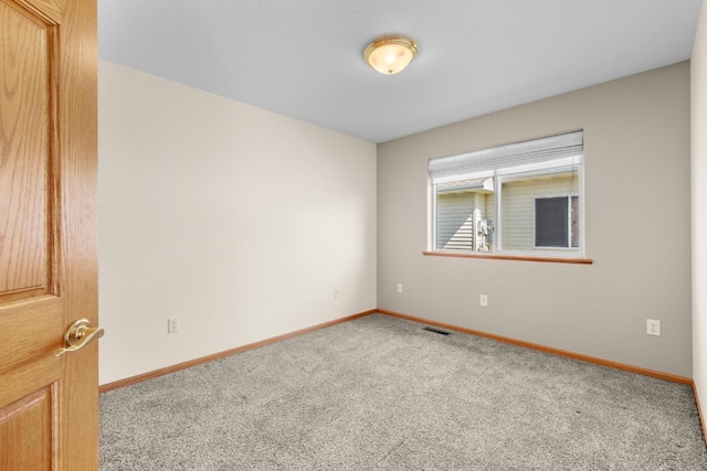 1949 24th St, Minot, ND 58701 - carpeted empty room with baseboards