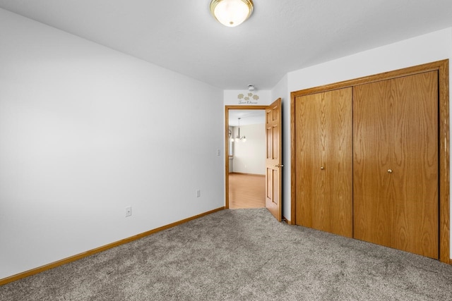 1949 24th St, Minot, ND 58701 - unfurnished bedroom featuring carpet floors and a closet