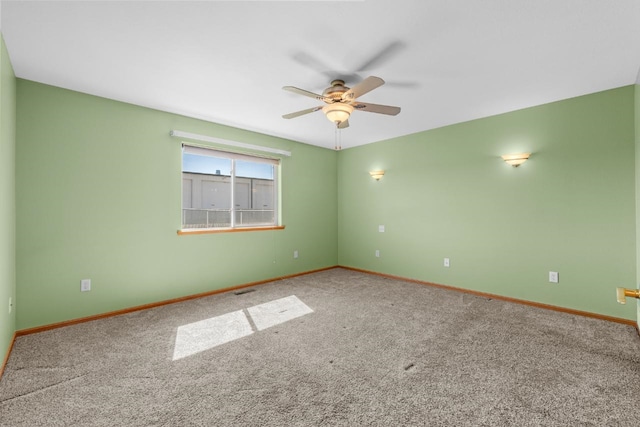 1949 24th St, Minot, ND 58701 - spare room featuring ceiling fan and carpet
