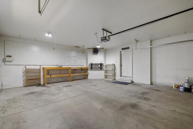 1949 24th St, Minot, ND 58701 - garage featuring a garage door opener and a workshop area