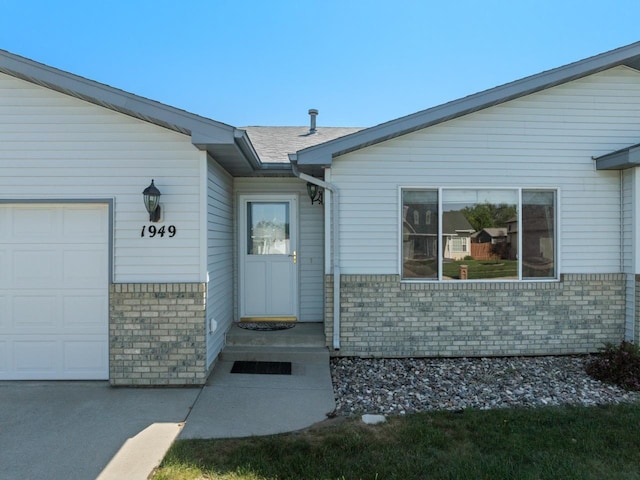 1949 24th St, Minot, ND 58701 - entrance to property with a garage and brick siding