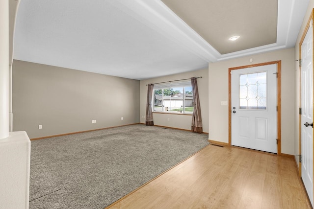 1949 24th St, Minot, ND 58701 - foyer with light wood-style floors and a tray ceiling