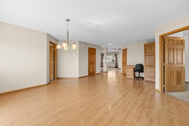 1949 24th St, Minot, ND 58701 - unfurnished living room with light wood-type flooring and a chandelier