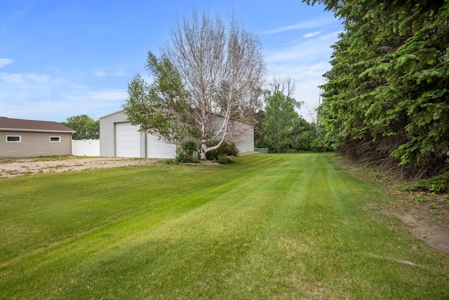 2710 66th St, Minot, ND 58703 - view of yard with a detached garage and an outdoor structure