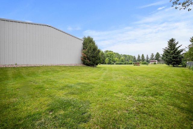 2710 66th St, Minot, ND 58703 - view of grassy yard with a pole building and an outbuilding