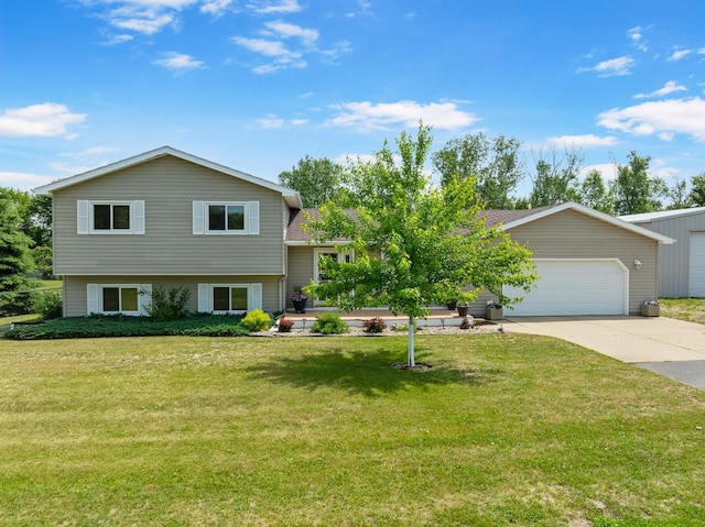 2710 66th St, Minot, ND 58703 - tri-level home featuring driveway, a front yard, and an attached garage