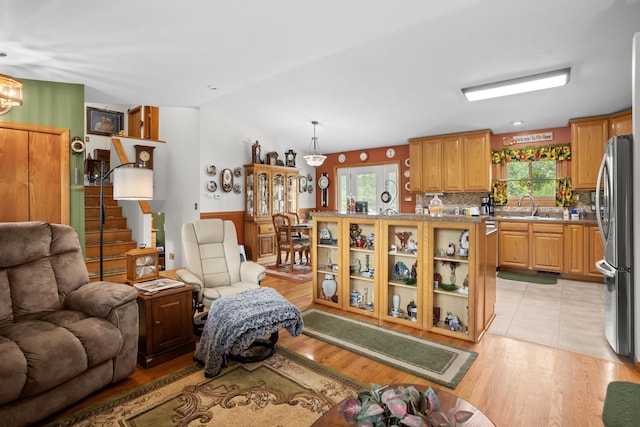 2710 66th St, Minot, ND 58703 - living room with light wood-style floors and vaulted ceiling