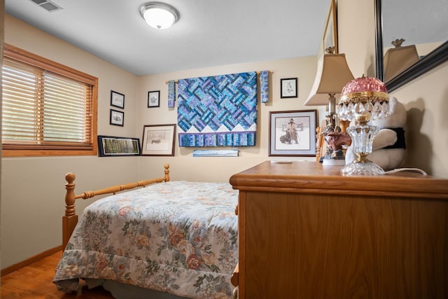 2710 66th St, Minot, ND 58703 - bedroom with wood finished floors and baseboards