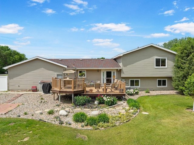 2710 66th St, Minot, ND 58703 - rear view of house featuring a wooden deck and a lawn