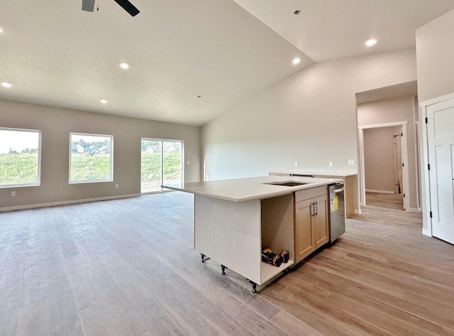 1609 Heights Ave, Burlington, ND 58722 - kitchen featuring vaulted ceiling, open floor plan, light wood finished floors, recessed lighting, and a kitchen island with sink