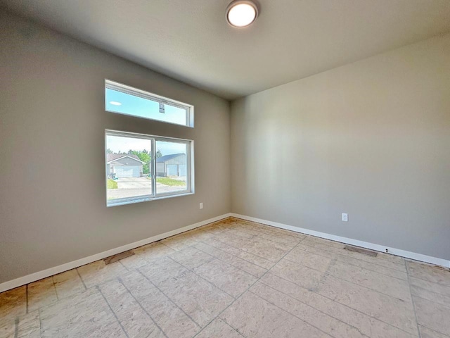 1609 Heights Ave, Burlington, ND 58722 - spare room featuring baseboards and light tile patterned floors