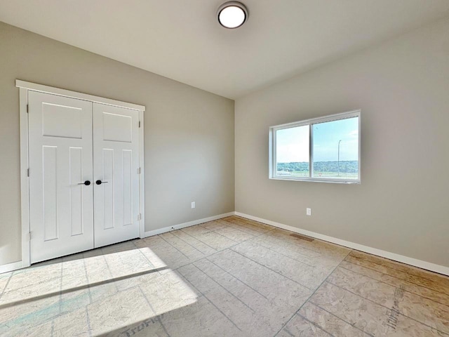 1609 Heights Ave, Burlington, ND 58722 - unfurnished bedroom featuring baseboards and a closet