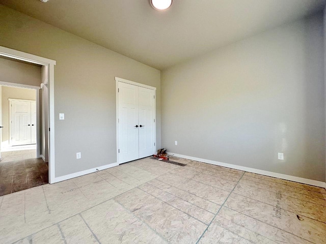1609 Heights Ave, Burlington, ND 58722 - unfurnished bedroom with baseboards and a closet