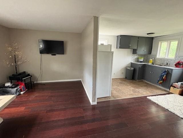 724 Burdick Expy, Minot, ND 58701 - kitchen featuring light wood-style flooring, light countertops, backsplash, and gray cabinets