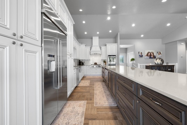 2009 35th Ave, Minot, ND 58701 - kitchen featuring stainless steel appliances, white cabinetry, custom range hood, recessed lighting, and light countertops