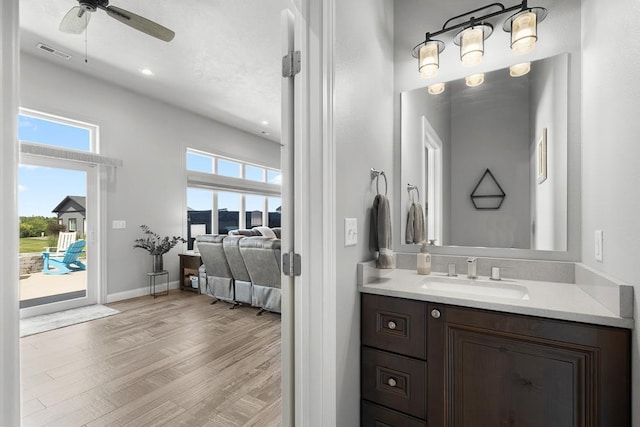 2009 35th Ave, Minot, ND 58701 - ensuite bathroom with vanity, a ceiling fan, wood finished floors, and recessed lighting