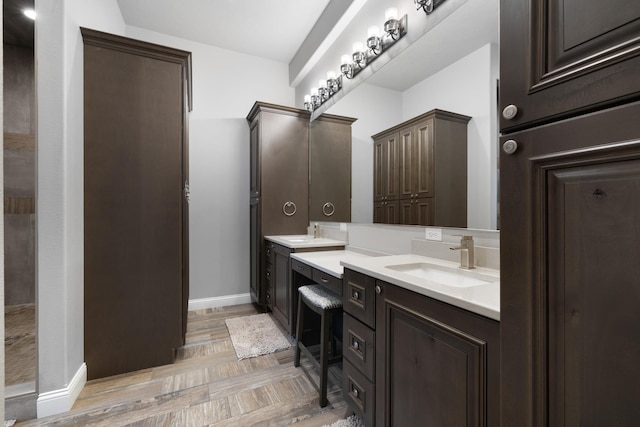 2009 35th Ave, Minot, ND 58701 - bathroom featuring double vanity and baseboards