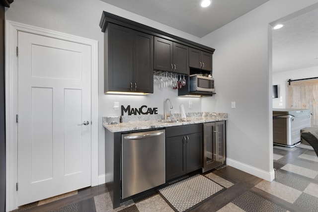 2009 35th Ave, Minot, ND 58701 - indoor wet bar featuring appliances with stainless steel finishes, beverage cooler, recessed lighting, and a barn door