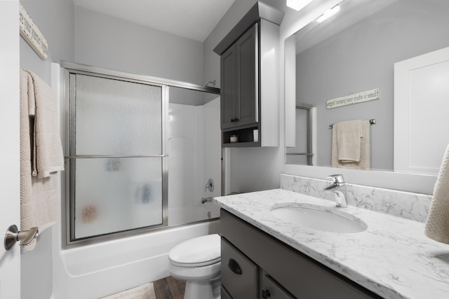 2009 35th Ave, Minot, ND 58701 - bathroom with vanity, shower / bath combination with glass door, and wood finished floors
