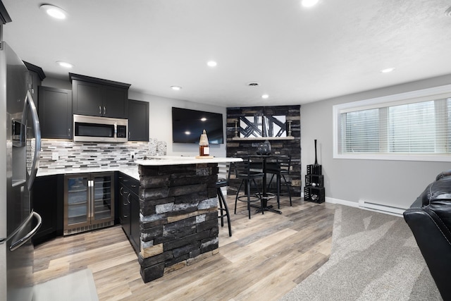 2009 35th Ave, Minot, ND 58701 - kitchen featuring wine cooler, appliances with stainless steel finishes, dark cabinetry, baseboard heating, and recessed lighting
