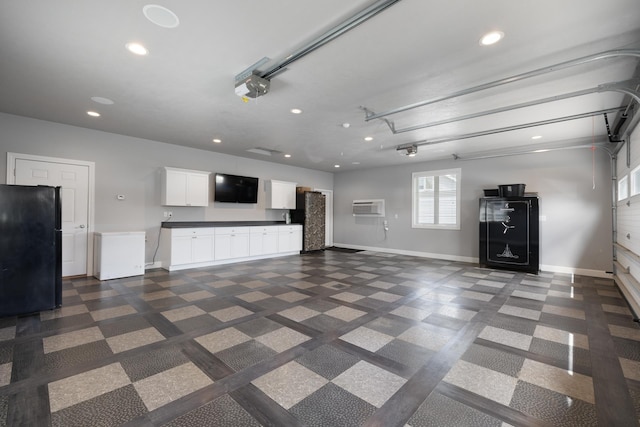 2009 35th Ave, Minot, ND 58701 - garage with freestanding refrigerator, an AC wall unit, recessed lighting, and a garage door opener