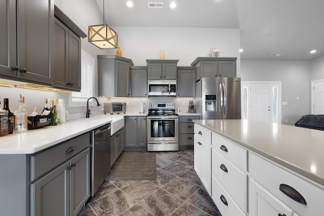 2009 35th Ave, Minot, ND 58701 - kitchen featuring stainless steel appliances, gray cabinets, recessed lighting, dark marble finish flooring, and light countertops