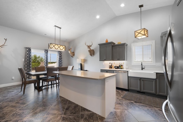 2009 35th Ave, Minot, ND 58701 - kitchen featuring stainless steel appliances, plenty of natural light, gray cabinetry, vaulted ceiling, and recessed lighting
