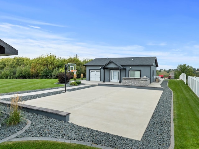 2009 35th Ave, Minot, ND 58701 - view of front of house featuring an attached garage, concrete driveway, stucco siding, and roof with shingles