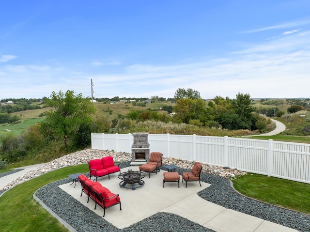 2009 35th Ave, Minot, ND 58701 - fenced backyard with a patio area and an outdoor living space with a fireplace