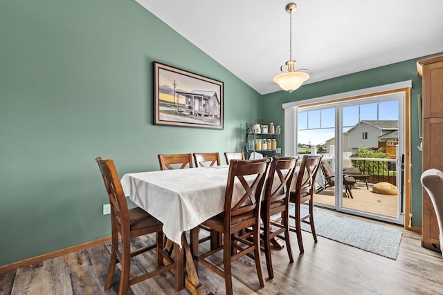 1808 28th St, Minot, ND 58703 - dining room featuring vaulted ceiling and light wood-style floors