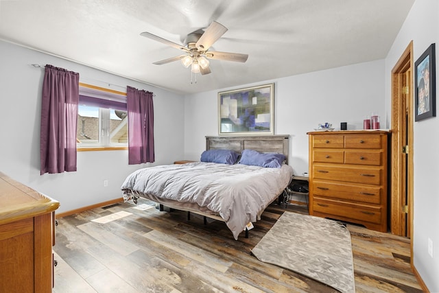 1808 28th St, Minot, ND 58703 - bedroom with wood finished floors and ceiling fan