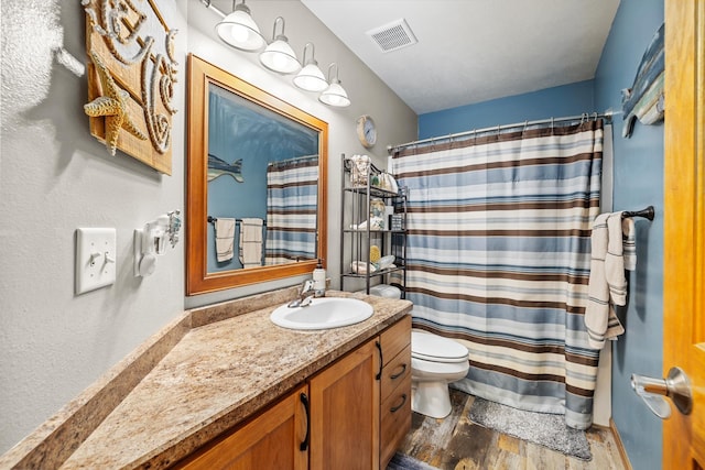 1808 28th St, Minot, ND 58703 - full bathroom with wood finished floors, vanity, and a shower with curtain
