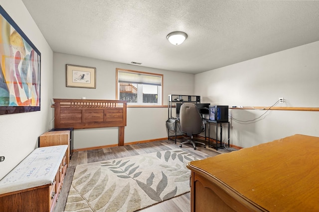 1808 28th St, Minot, ND 58703 - office space with light wood-style floors and a textured ceiling