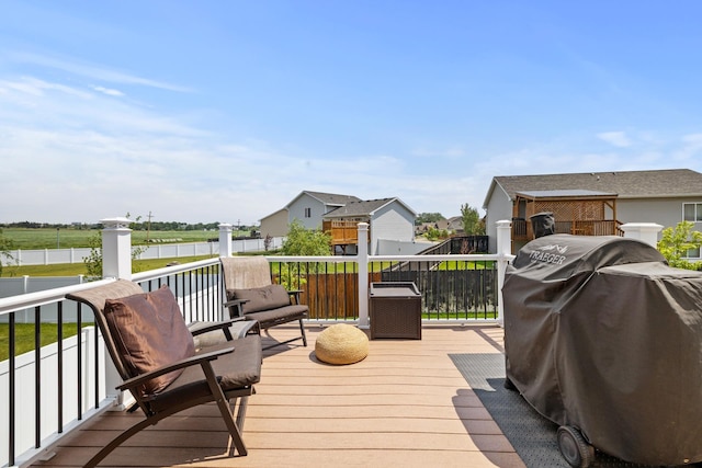 1808 28th St, Minot, ND 58703 - wooden deck with grilling area, a water view, and a residential view