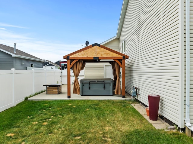 1808 28th St, Minot, ND 58703 - fenced backyard featuring a hot tub, a gazebo, and a patio