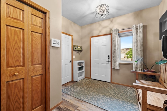 1808 28th St, Minot, ND 58703 - foyer entrance featuring baseboards and wood finished floors