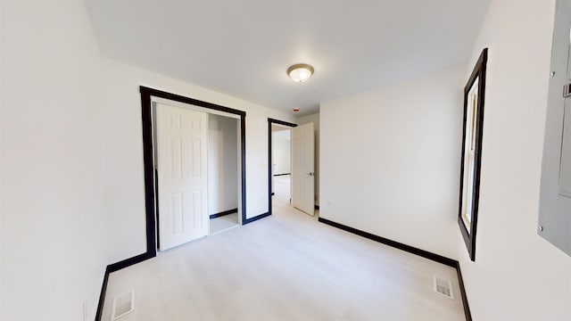 1113 10th St, Minot, ND 58703 - unfurnished bedroom featuring baseboards