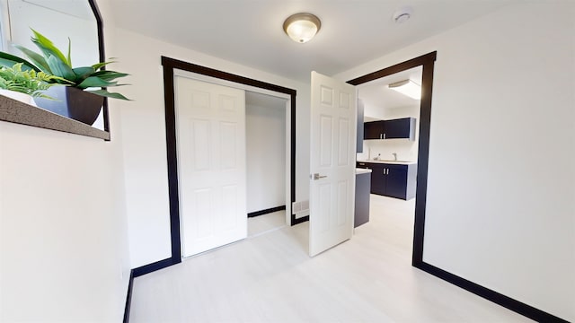1113 10th St, Minot, ND 58703 - hall featuring light wood-type flooring and a sink