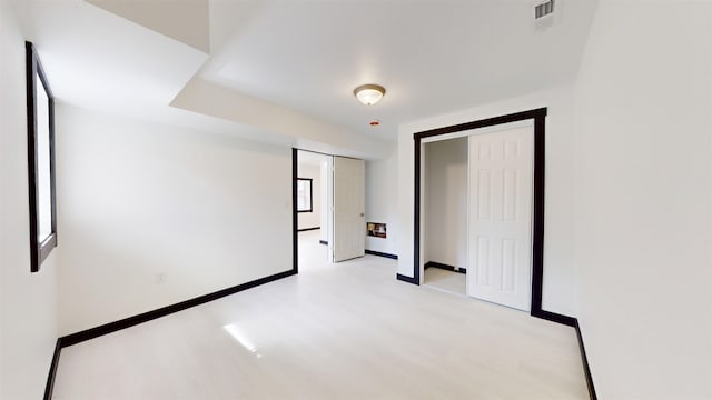 1113 10th St, Minot, ND 58703 - unfurnished room with light wood-style flooring and baseboards