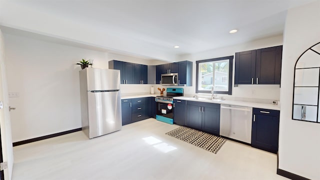 1113 10th St, Minot, ND 58703 - kitchen featuring stainless steel appliances, light countertops, recessed lighting, light wood-style flooring, and blue cabinets