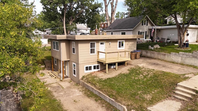 1113 10th St, Minot, ND 58703 - rear view of property with a yard and a deck