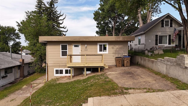 1113 10th St, Minot, ND 58703 - rear view of house featuring a yard and a wooden deck