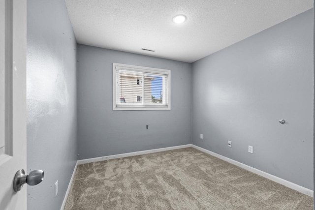 606 19th Ave Unit 7, Minot, ND 58701 - empty room featuring carpet floors and a textured ceiling