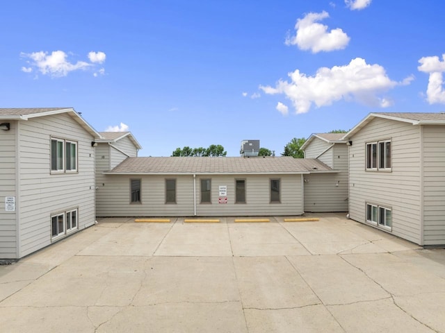 606 19th Ave Unit 7, Minot, ND 58701 - back of property with a patio area and uncovered parking