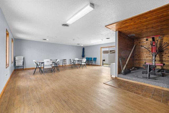 606 19th Ave Unit 7, Minot, ND 58701 - recreation room with wooden walls and wood finished floors