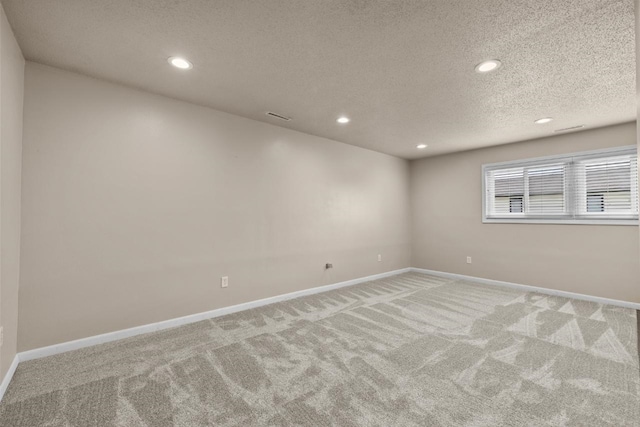 606 19th Ave Unit 7, Minot, ND 58701 - carpeted empty room with a textured ceiling and recessed lighting