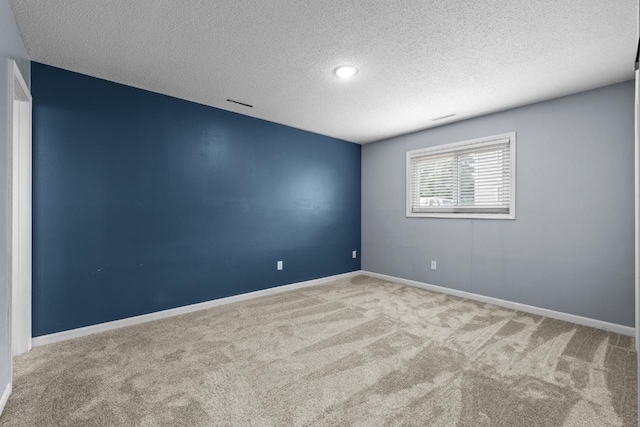 606 19th Ave Unit 7, Minot, ND 58701 - spare room featuring carpet and a textured ceiling