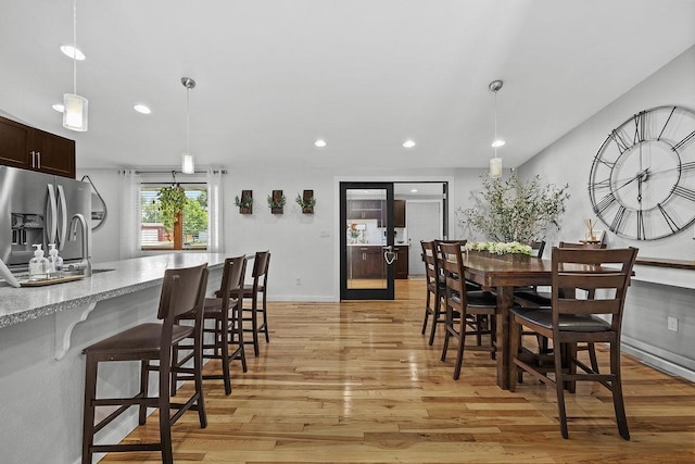 120 25th St, Minot, ND 58701 - dining area with light wood-type flooring and recessed lighting