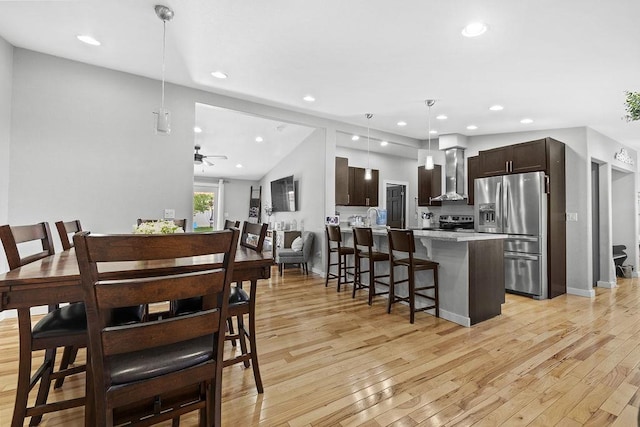120 25th St, Minot, ND 58701 - dining area featuring light wood-style floors, recessed lighting, ceiling fan, and lofted ceiling