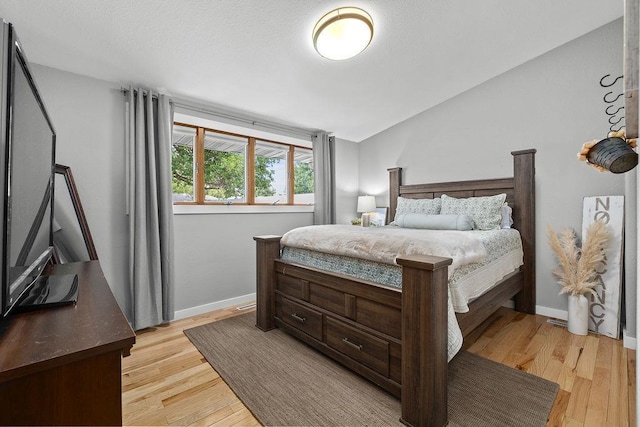120 25th St, Minot, ND 58701 - bedroom with light wood-style flooring and lofted ceiling